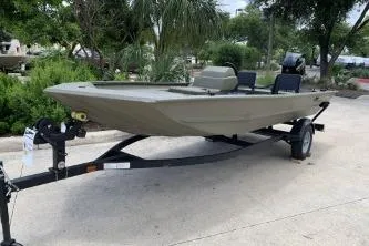 Slide: The Image of 2026 Tracker Grizzly 1754 SC boat on trailer, parked outdoors. - 3