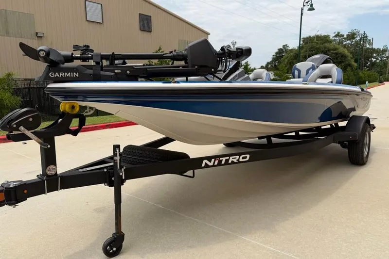 Slide: The Image of 2026 Nitro Z18 Pro boat on trailer with Garmin equipment, parked outdoors. - 3