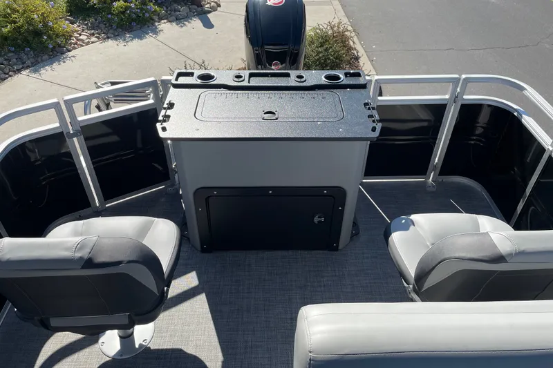 Slide: The Image of 2026 Sun Tracker SportFish 20 DLX boat interior with seating and storage area. - 19