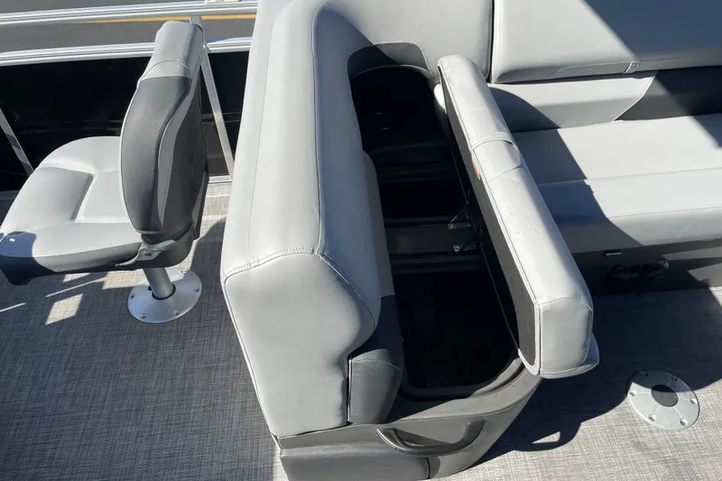 Slide: The Image of 2026 Sun Tracker SportFish 20 DLX boat interior with open storage compartment and seating. - 16