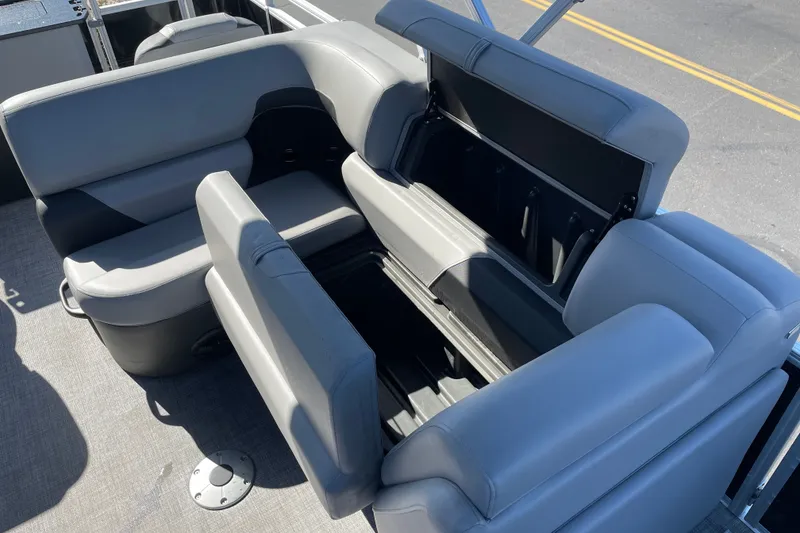 Slide: The Image of 2026 Sun Tracker SportFish 20 DLX boat interior with open storage compartment and gray seating. - 14
