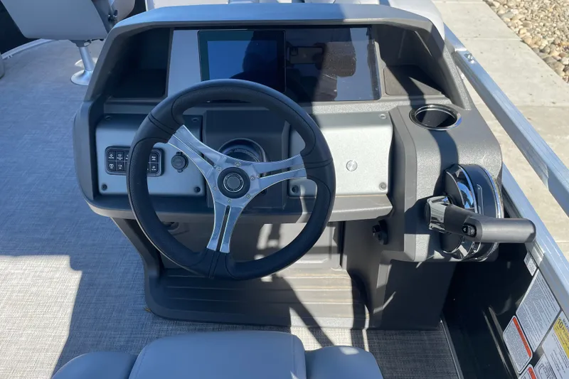 Slide: The Image of Steering console of 2026 Sun Tracker SportFish 20 DLX pontoon boat, featuring modern controls. - 17