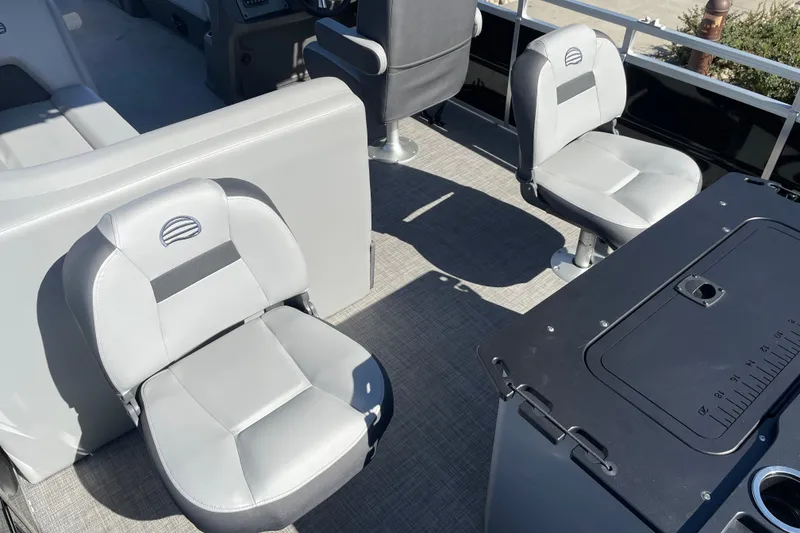 Slide: The Image of 2026 Sun Tracker SportFish 20 DLX interior with gray seating and fishing station. - 22