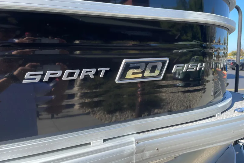 Slide: The Image of 2026 Sun Tracker SportFish 20 DLX boat logo on black exterior. - 25