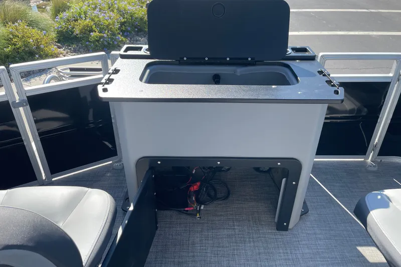 Slide: The Image of Sun Tracker SportFish 20 DLX 2026 boat interior with seating and storage compartment. - 20
