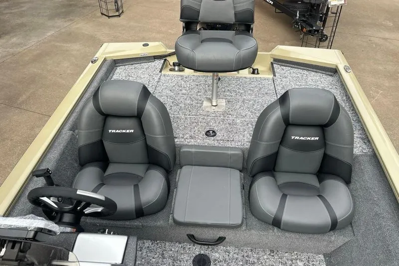 Slide: The Image of 2026 Tracker Pro Team 190 boat interior with gray seating and steering wheel. - 14