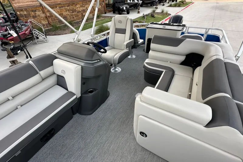 Slide: The Image of 2026 Sun Tracker Fishin' Barge 20 DLX interior with spacious seating and modern helm. - 51