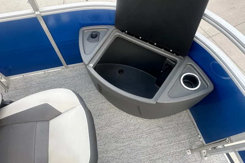 Slide: The Image of 2026 Sun Tracker Fishin' Barge 20 DLX interior with seating and storage compartment. - 60
