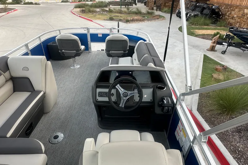 Slide: The Image of 2026 Sun Tracker Fishin' Barge 20 DLX interior with steering console and seating. - 56