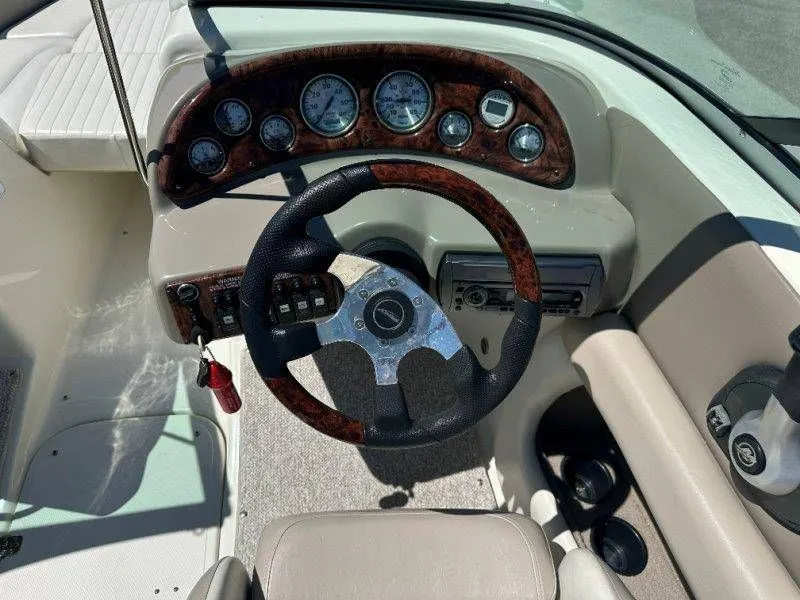 Slide: The Image of Interior view of a 2009 Caravelle 237 boat cockpit with wood trim. - 39