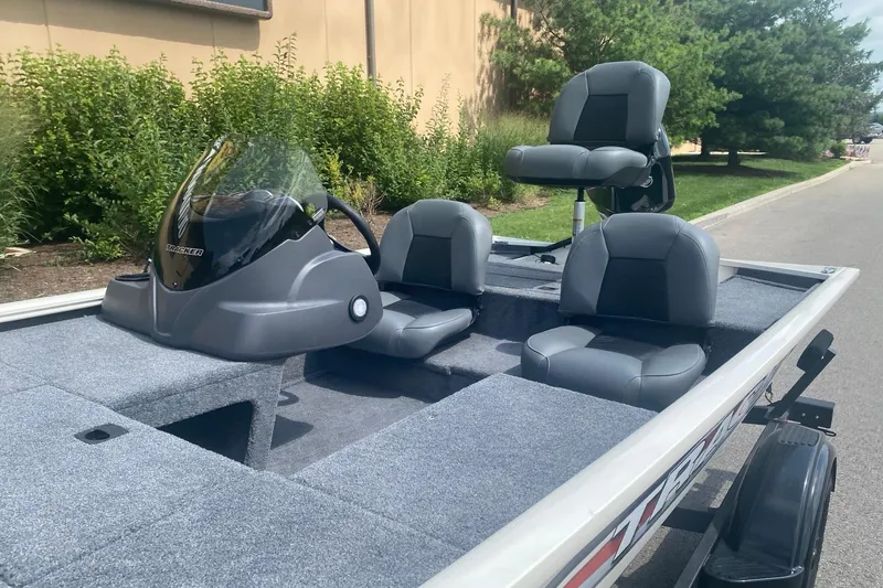 Slide: The Image of 2026 Tracker Pro 170 boat with seating, parked outdoors on a sunny day. - 3