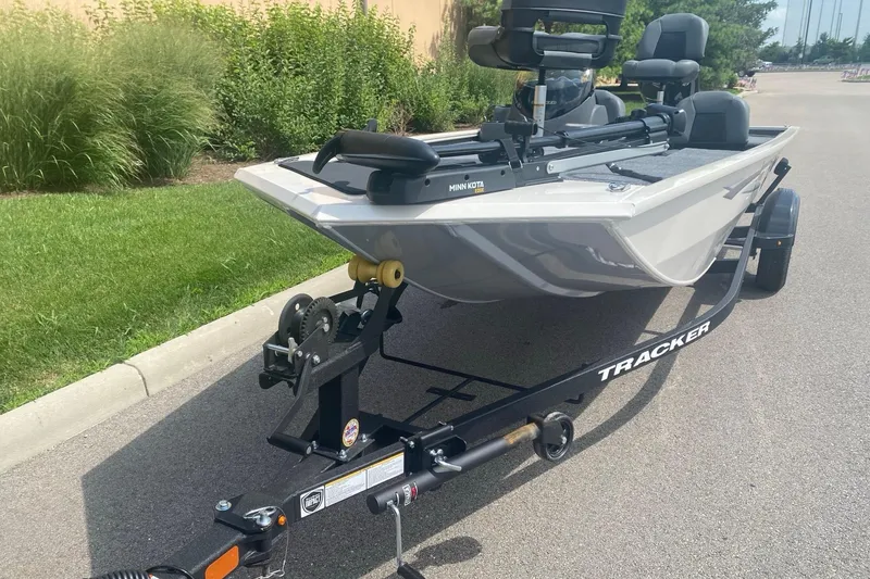 Slide: The Image of 2026 Tracker Pro 170 boat on trailer, parked on a paved road. - 2
