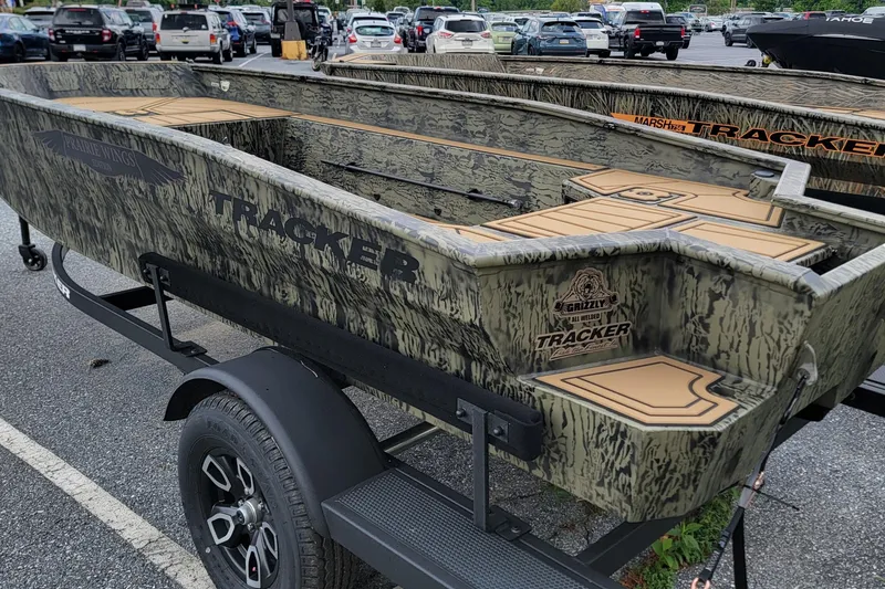 Slide: The Image of 2026 Tracker Grizzly 1650 T Prairie Wings Edition boat on trailer in parking lot. - 3