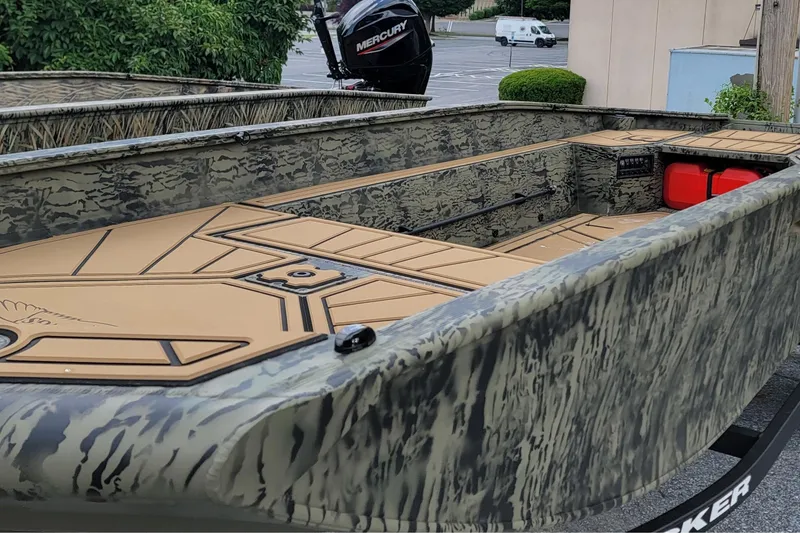 Slide: The Image of 2026 Tracker Grizzly 1650 T Prairie Wings Edition boat with camouflage design and spacious interior. - 2