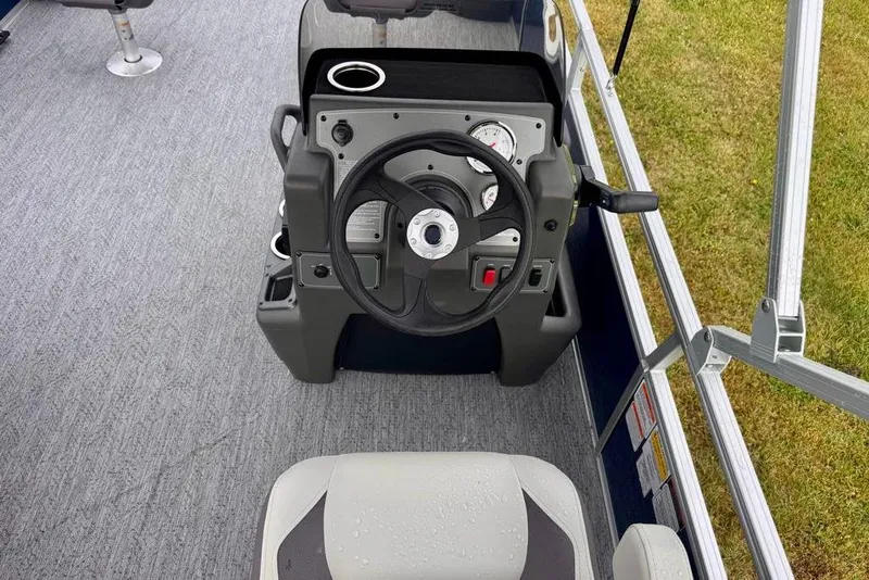 Slide: The Image of 2026 Sun Tracker Bass Buggy 18 DLX steering console with gauges and controls. - 14