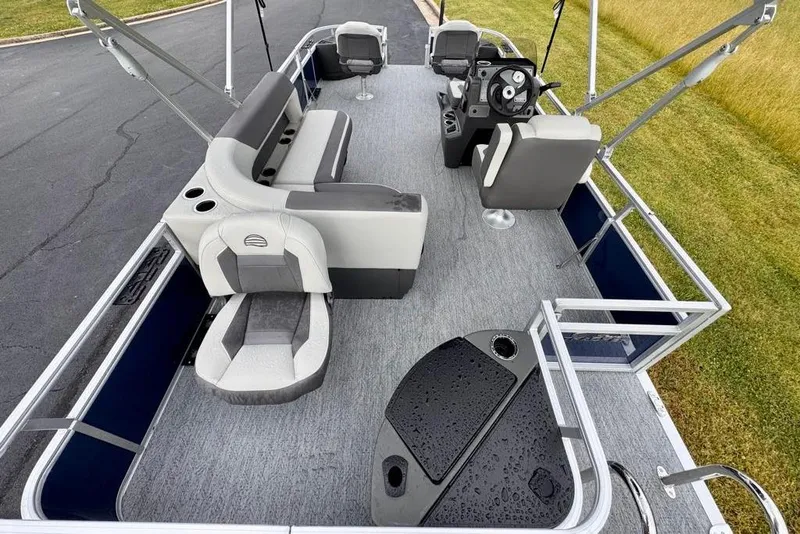 Slide: The Image of 2026 Sun Tracker Bass Buggy 18 DLX pontoon boat interior with seating and steering console. - 13