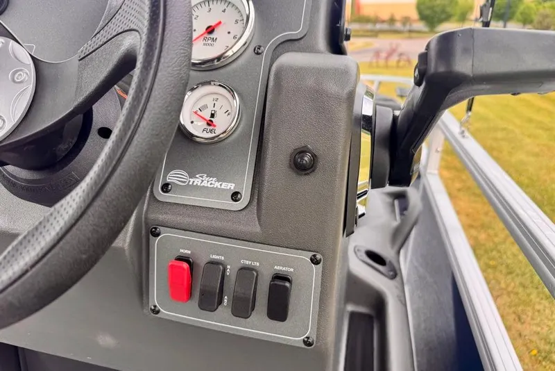 Slide: The Image of Close-up of 2026 Sun Tracker Bass Buggy 18 DLX dashboard with gauges and controls. - 15