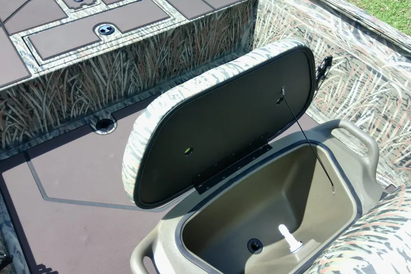 Slide: The Image of 2026 Tracker Grizzly 1860 CC boat interior with open storage compartment. - 20