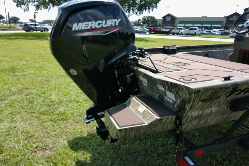 Slide: The Image of 2026 Tracker Grizzly 1860 CC boat with Mercury engine on grassy area. - 16