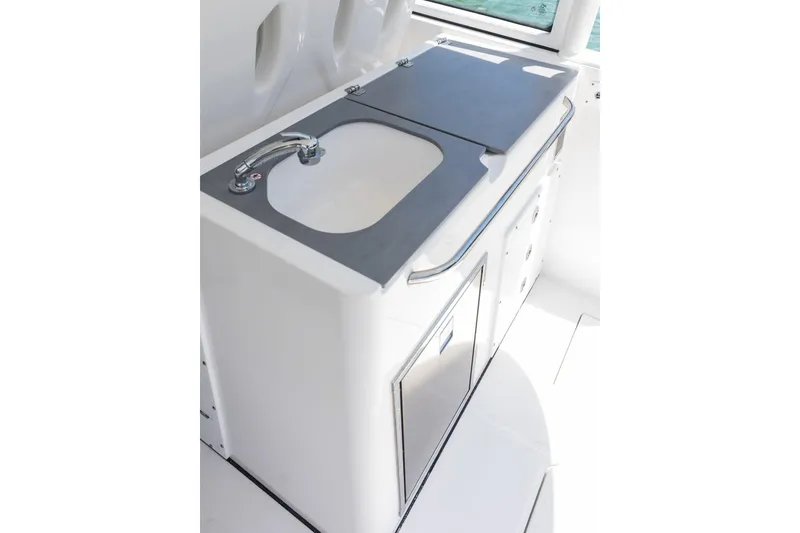 Slide: The Image of Edgewater 2026 boat sink with stainless steel faucet and storage cabinets. - 13