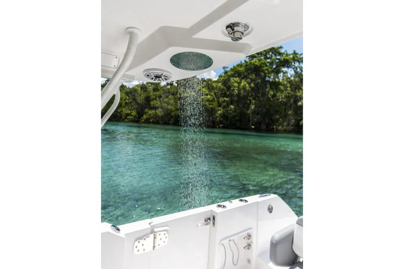 Slide: The Image of Outdoor shower on 2026 Edgewater boat with scenic water and forest backdrop. - 16