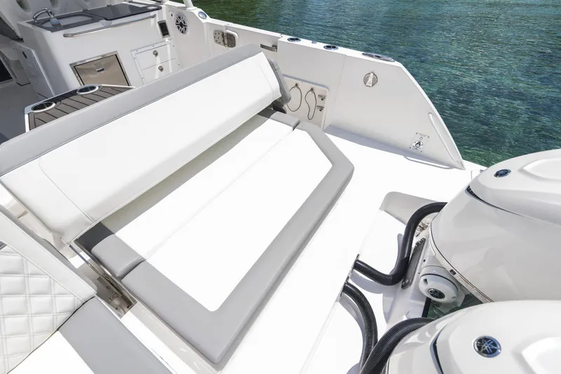 Slide: The Image of Luxurious 2026 Edgewater boat interior with white seating and dual outboard motors. - 19