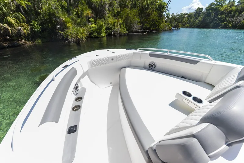 Slide: The Image of Luxurious 2026 Edgewater boat interior with plush seating, cruising on a serene, clear river. - 2