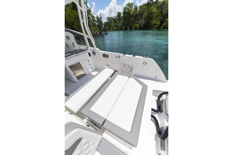 Slide: The Image of Luxurious 2026 Edgewater boat interior with white seating, overlooking a serene river. - 20