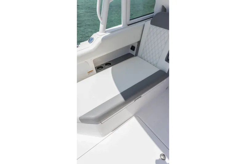 Slide: The Image of Interior seating of 2026 Edgewater boat with cup holders and quilted upholstery. - 22