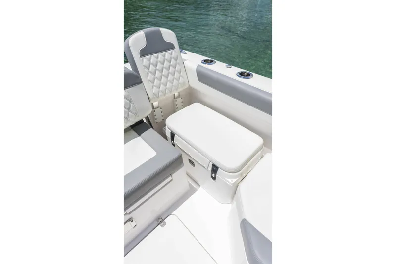 Slide: The Image of 2026 Edgewater boat interior with cushioned seating and storage, near water. - 23