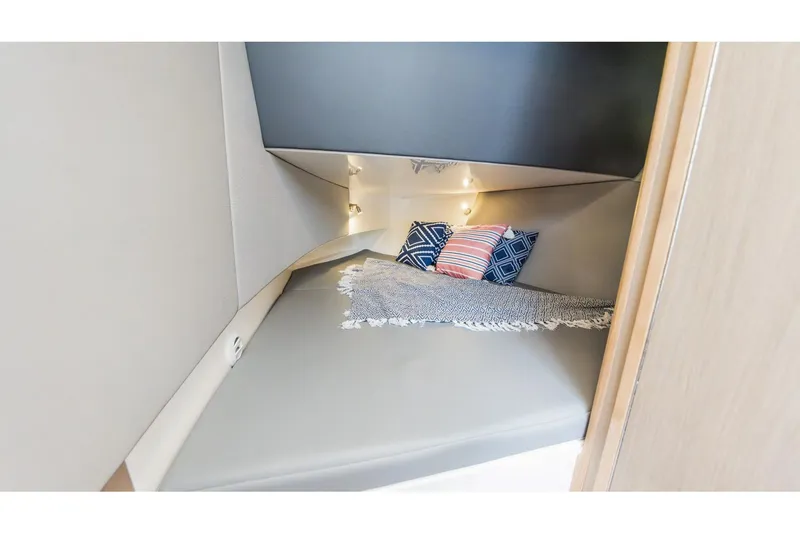 Slide: The Image of Cozy cabin interior of 2026 Edgewater boat with cushions and soft lighting. - 26