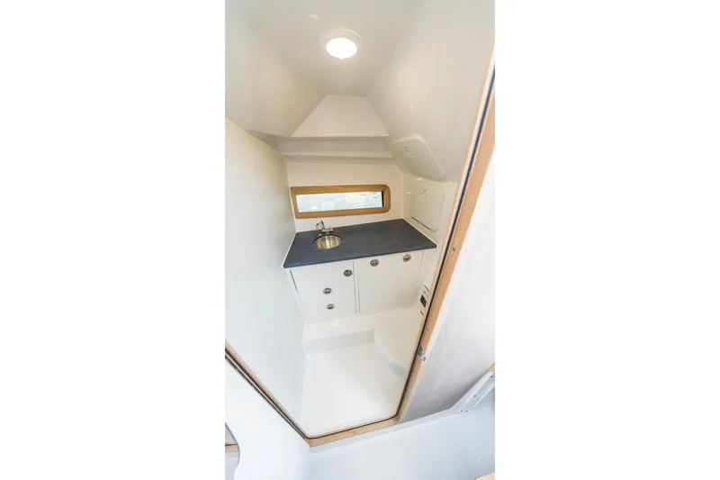 Slide: The Image of Compact bathroom interior in 2026 Edgewater model, featuring sink and storage cabinets. - 27