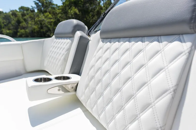Slide: The Image of Luxurious white leather boat seats with cup holders, Edgewater 2026 model. - 4