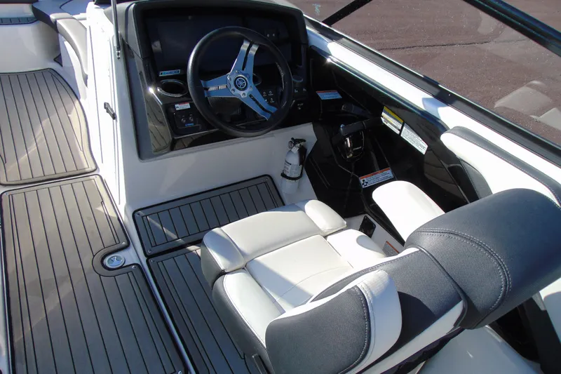 Slide: The Image of 2020 Yamaha Boats 242SE cockpit with steering wheel and seating. - 9