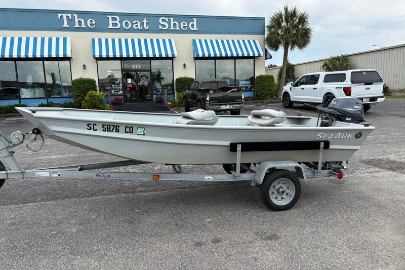 The Image of 2011 SeaArk 1448 MV boat on trailer outside The Boat Shed store. - 0