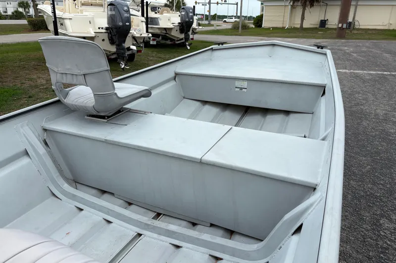Slide: The Image of 2011 SeaArk 1448 MV boat interior with seating and storage compartments. - 11