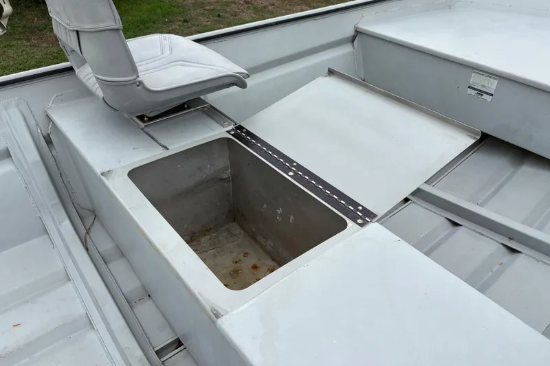 Slide: The Image of 2011 SeaArk 1448 MV boat interior with storage compartment and seat. - 12