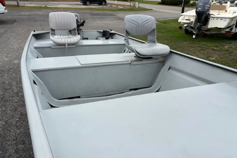 Slide: The Image of 2011 SeaArk 1448 MV boat with two seats, parked on pavement. - 14