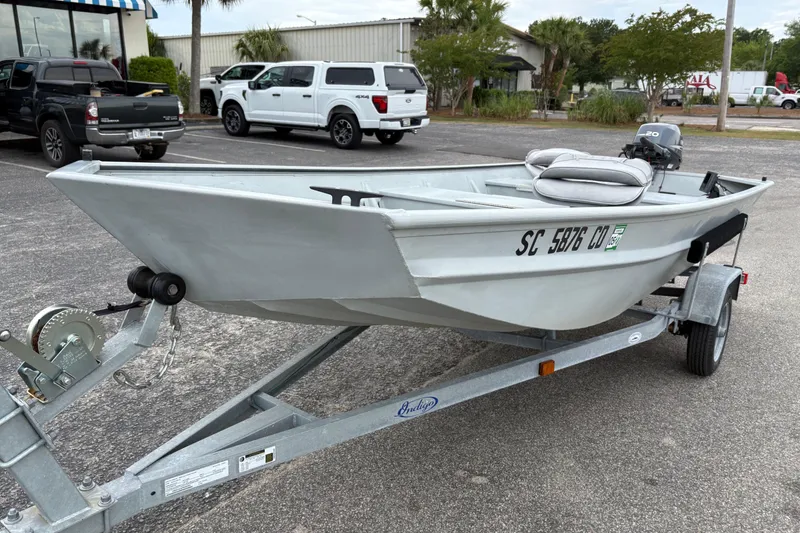 Slide: The Image of 2011 SeaArk 1448 MV boat on trailer in parking lot. - 7