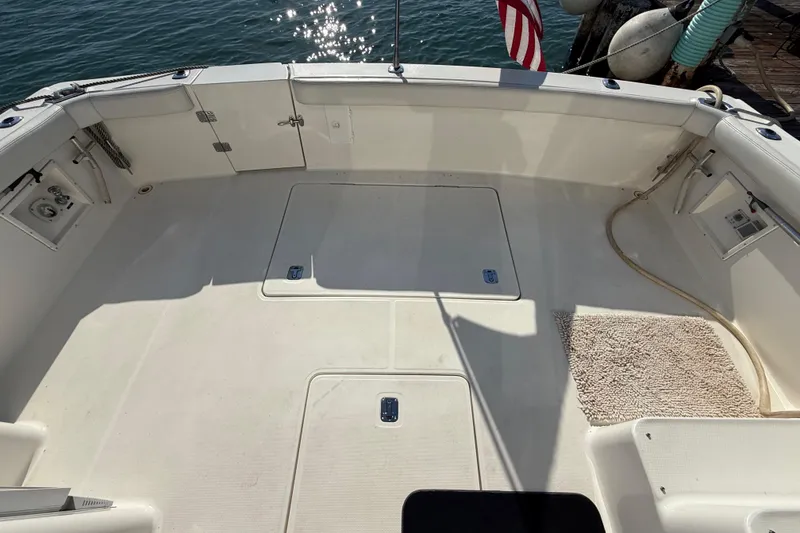 Slide: The Image of Spacious deck of a 2001 Silverton 42 Convertible boat with clean white surface. - 15