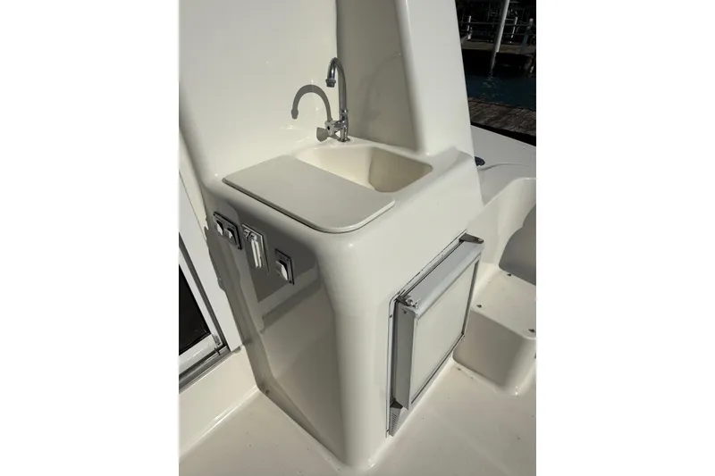 Slide: The Image of 2001 Silverton 42 Convertible yacht sink and storage area on deck. - 17