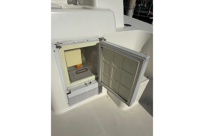 Slide: The Image of Open storage compartment on 2001 Silverton 42 Convertible boat deck. - 18