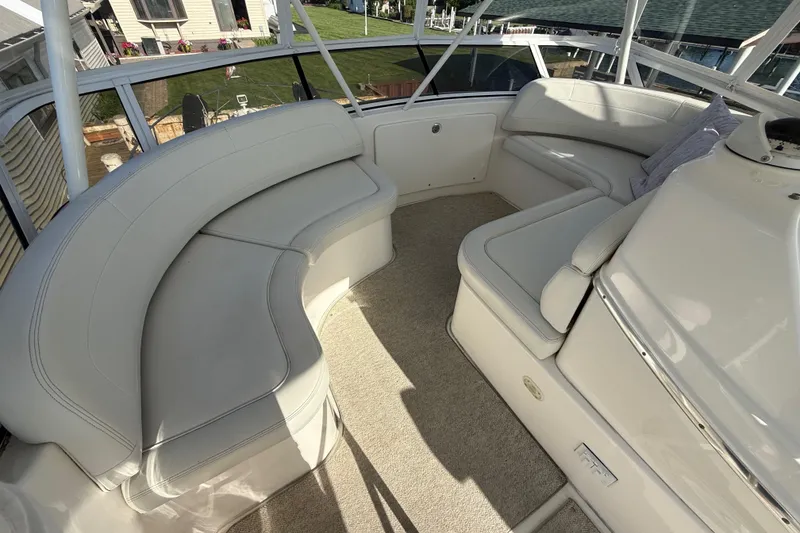 Slide: The Image of 2001 Silverton 42 Convertible yacht interior with plush seating and carpeted flooring. - 21