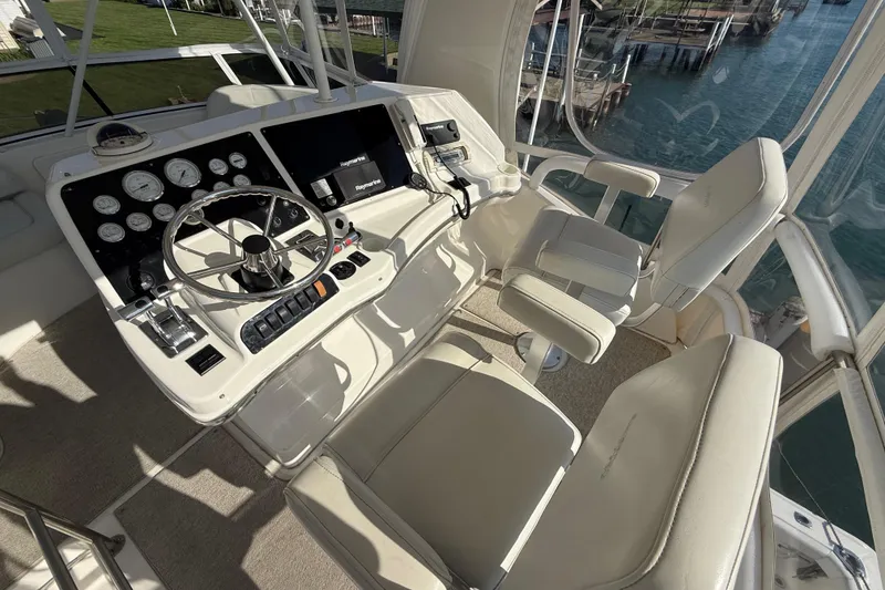 Slide: The Image of Cockpit of 2001 Silverton 42 Convertible yacht with steering wheel and control panel. - 24