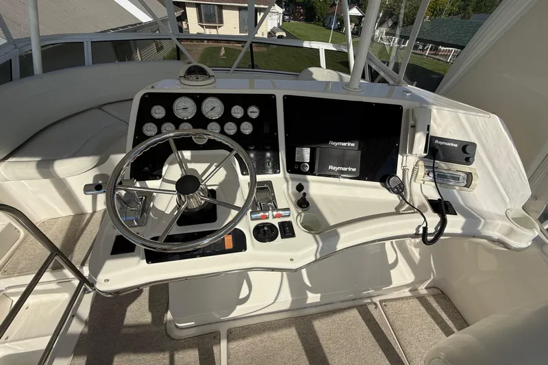 Slide: The Image of Helm of 2001 Silverton 42 Convertible yacht with steering wheel and navigation instruments. - 25