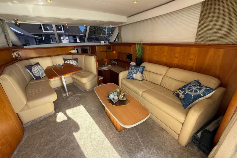 Slide: The Image of Luxurious interior of a 2001 Silverton 42 Convertible yacht with plush seating and nautical decor. - 29