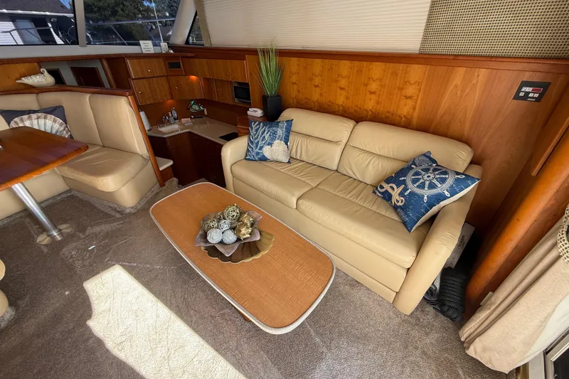 Slide: The Image of Luxurious interior of a 2001 Silverton 42 Convertible yacht with beige seating and nautical decor. - 30