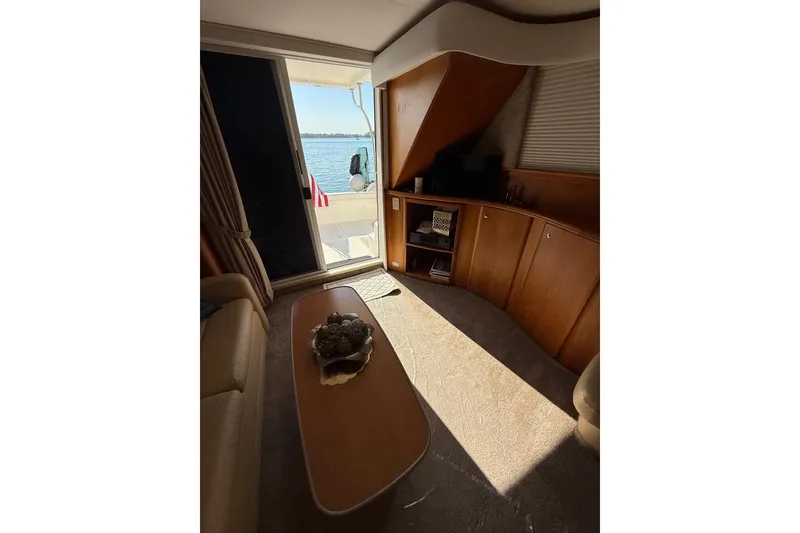 Slide: The Image of Interior of 2001 Silverton 42 Convertible yacht with elegant wood cabinetry and lake view. - 31