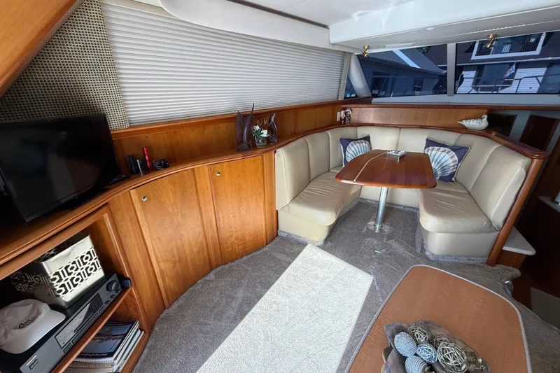 Slide: The Image of Luxurious interior of a 2001 Silverton 42 Convertible yacht with cozy seating and elegant decor. - 33