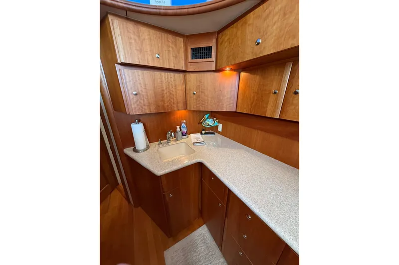 Slide: The Image of 2001 Silverton 42 Convertible yacht interior with wooden cabinets and countertop sink. - 35